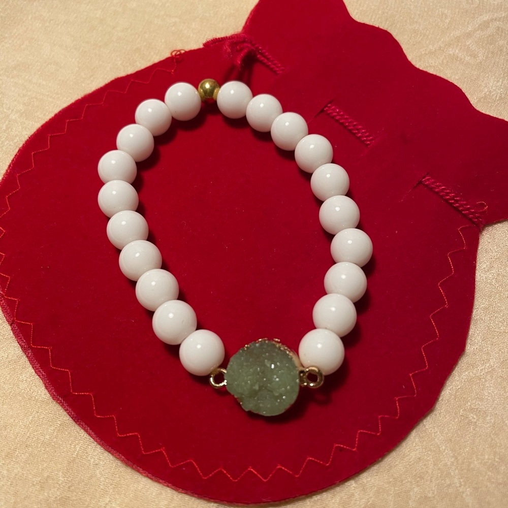 White beaded bracelet with gold accents